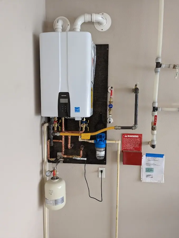 Professional plumber installing copper piping in a Spring Grove home